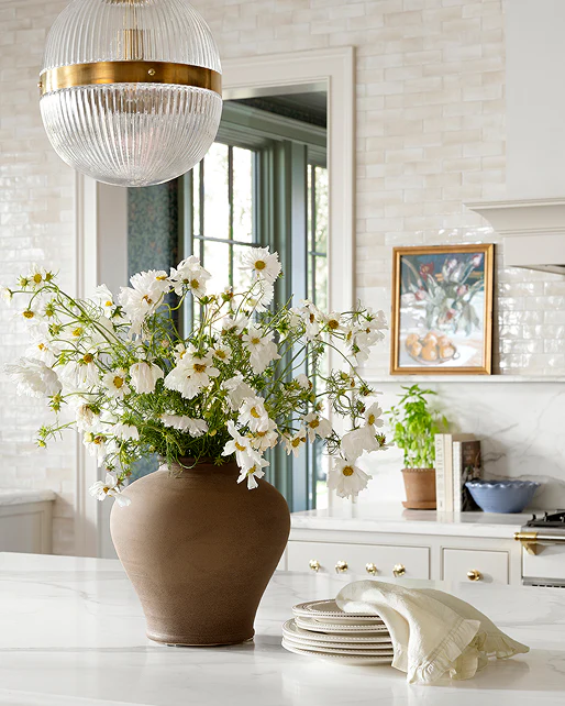 Styled kitchen counter with ceramic vase and tableware